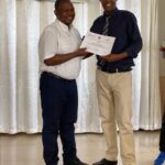 Dr MBONICURA giving certificate