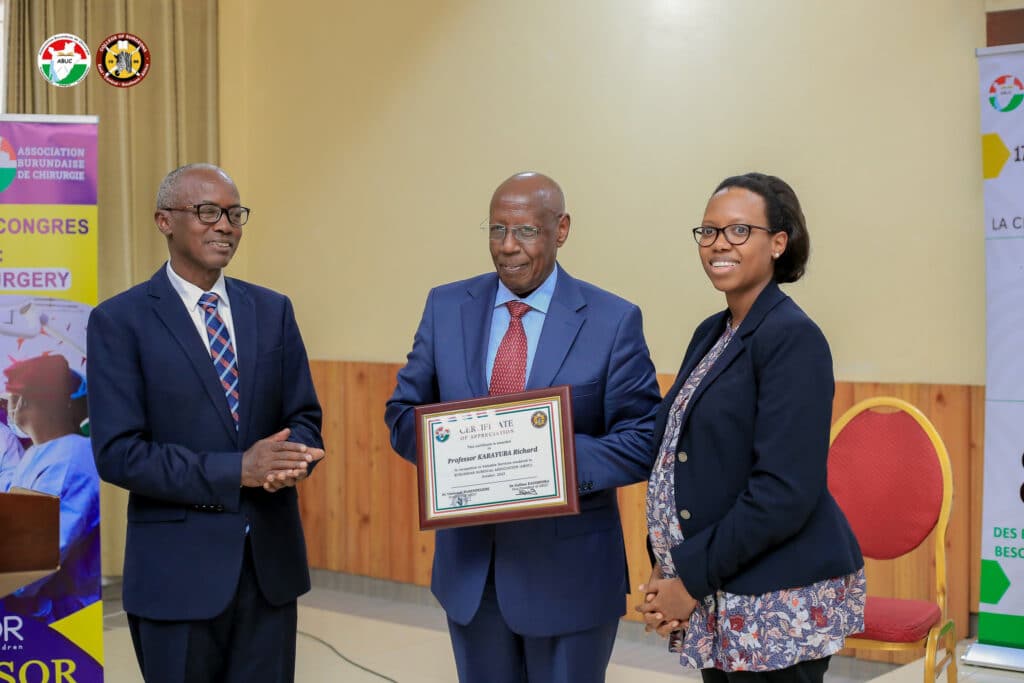 Dr Karayuba receiving a certificate